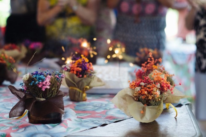 A table covered with small floral arrangements