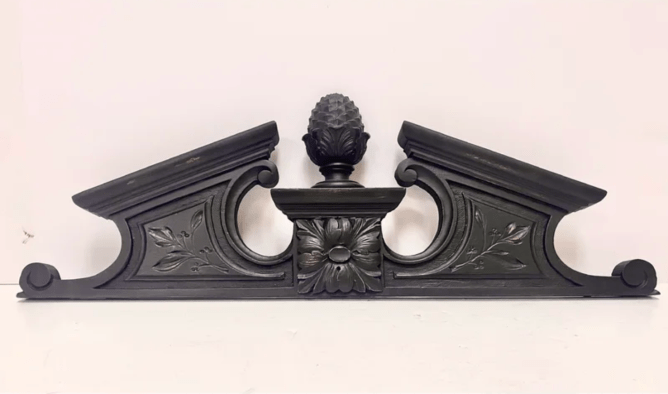 An ornate black window pediment