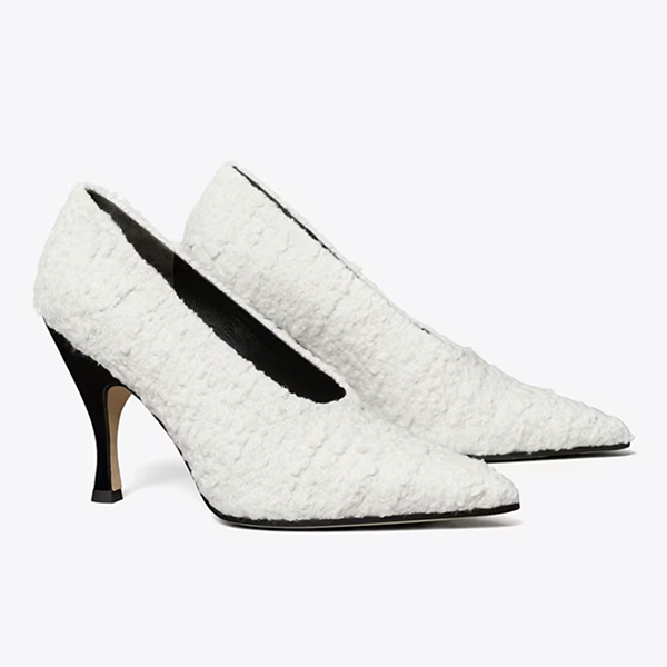 A pair of pointed-toe pumps lined with white bouclé fabric