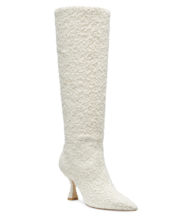 A knee-high, pointed-toe, high-heel boot lined with white bouclé fabric