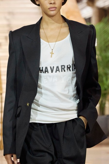 A model wearing a simple cross necklace