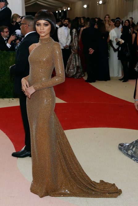 Zendaya in a one-sleeve gold sparkly gown at the 2016 Met Gala