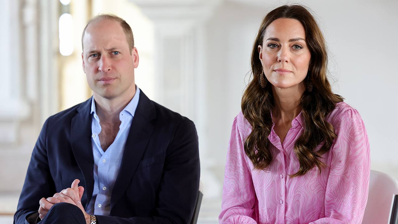 Prince William, a white man wearing a suit, and Kate Middleton, a white woman with brown hair wearing a pink blouse