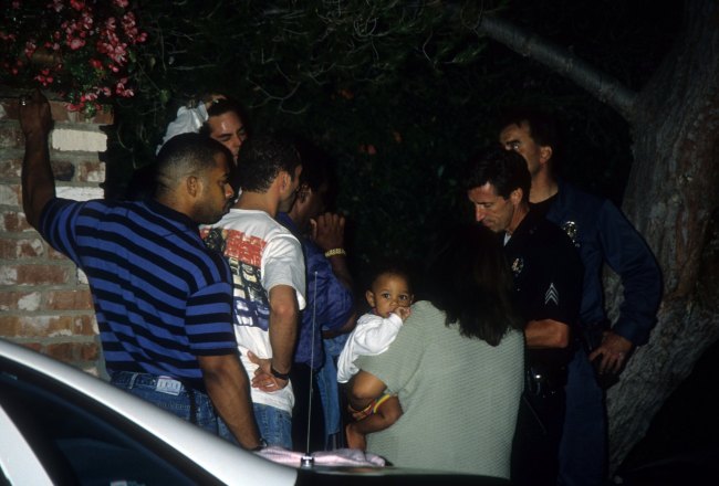 Carmelita Simpson Durio, sister of O.J. Simpson, talks to investigators near the crime scene where the murders of Nicole Brown Simpson and Ron Goldman took place on June 12, 1994 in Brentwood, California.