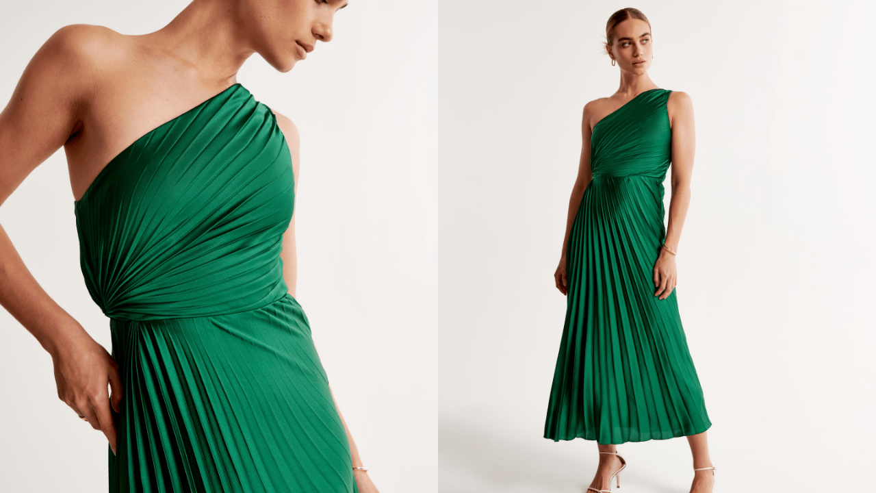 An emerald green pleated one shoulder dress.