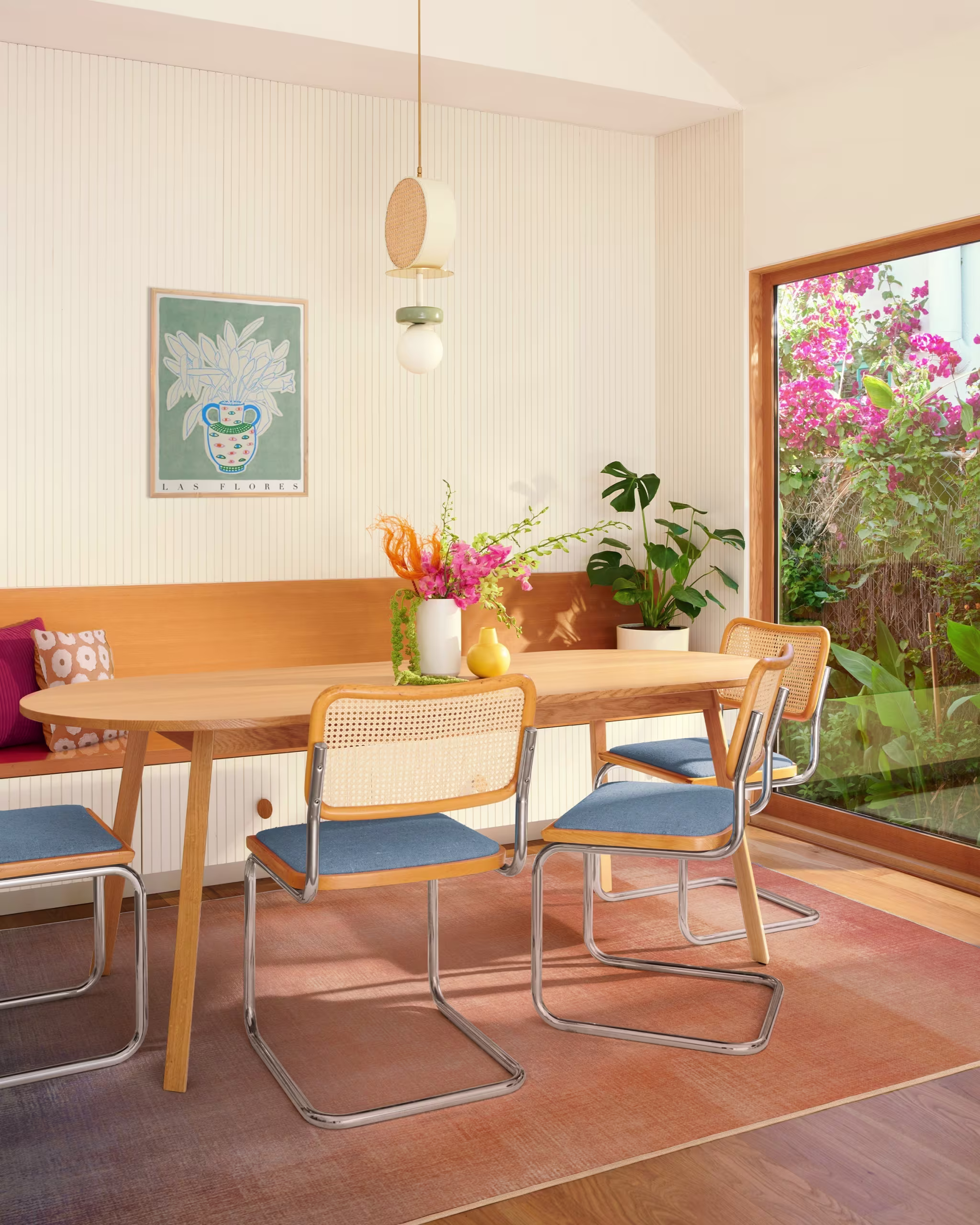 Peach ombre area rug in a kitchen with a wooden kitchen table on top.