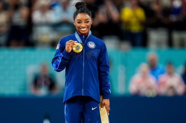 PARIS, FRANCE - AUGUST 3: Gold medalist Simone Biles of Team United States shows her medal during the medal ceremony after competing in the Women's Vault Final during Day 8 of Artistic Gymnastics - Olympic Games Paris 2024 at Bercy Arena on August 3, 2024 in Paris, France.