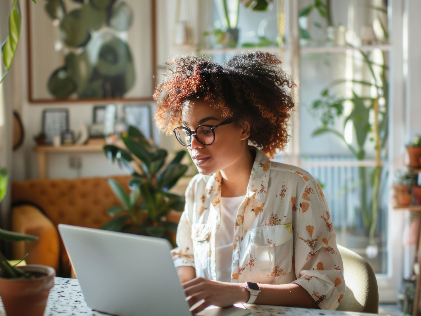 Woman working from home in office with plants