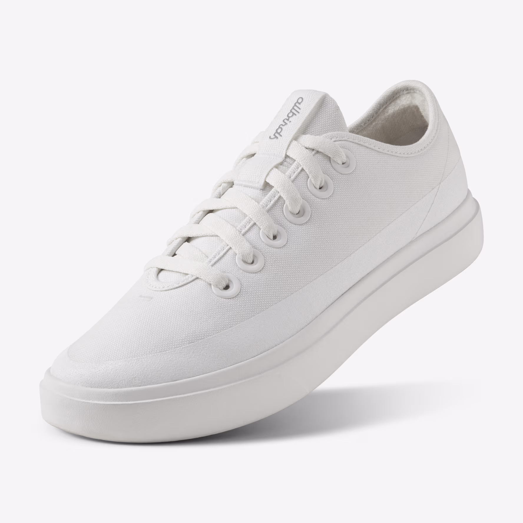 A chunky white running shoes with thick soles and mesh panels