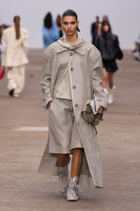 Model on Stella McCartney wears lace up boots.