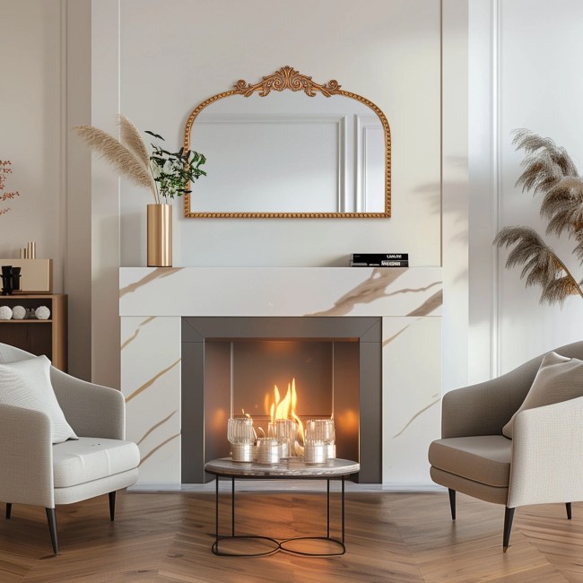 An antique-inspired mirror hanging above a fireplace mantel