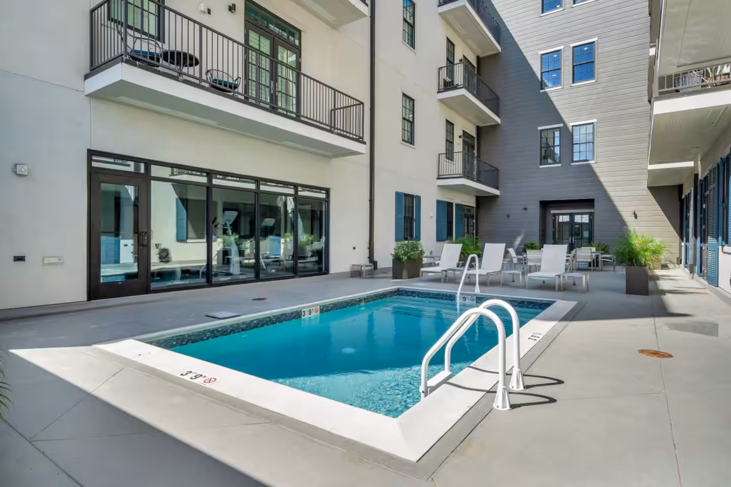 Exterior of apartment with a pool