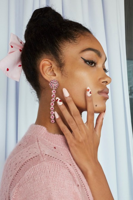 A model with pink and red heart nails.