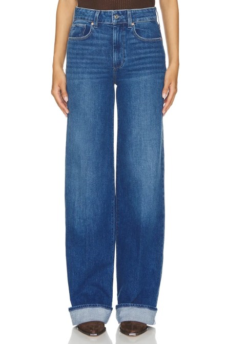 A model wearing the PAIGE Sasha Wide Cuff Jeans in a medium to dark denim wash