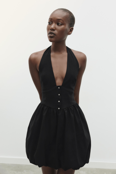 A model wearing the Zara Balloon Mini Dress in black