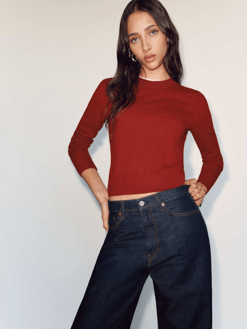 A model wearing Reformation's Dana Cashmere Crew Sweater in Crimson