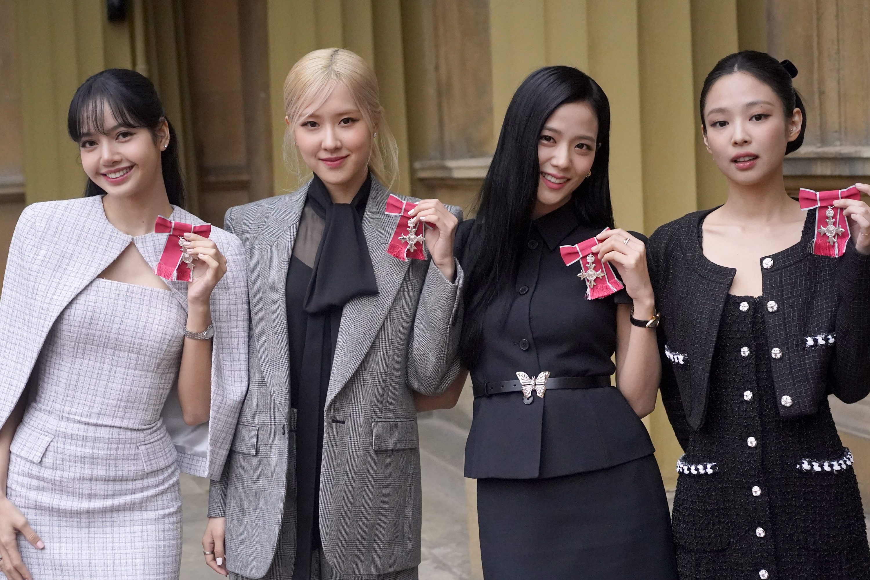 LONDON, ENGLAND - NOVEMBER 22: (left to right) Lisa (Lalisa Manoban), Rose (Roseanne Park), Jisoo Kim and Jennie Kim, from the K-Pop band Blackpink pose with their Honorary MBEs (Members of the Order of the British Empire), awarded to them in recognition of the band's role as COP26 advocates for the COP26 Summit in Glasgow 2021 on November 22, 2023 in London, England. King Charles III conducted the special Investiture ceremony in the presence of the President of South Korea, Yoon Suk Yeol, and his wife, Kim Keon Hee. (Photo by Victoria Jones - Pool/Getty Images)